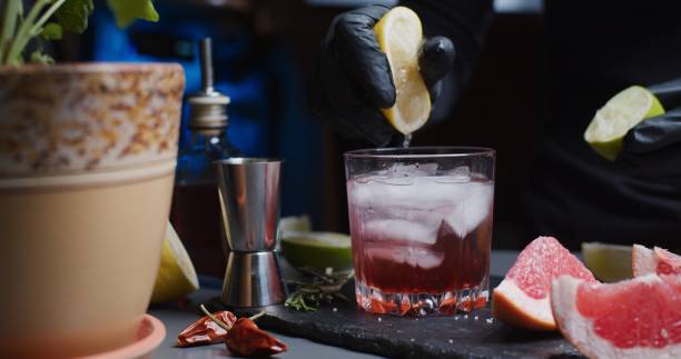 istock Human hands are making a mocktail with various citrus juices and rosemary 1286671416