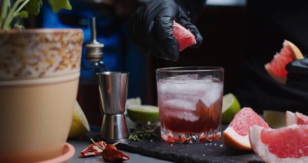 istock Human hands are making a mocktail with various citrus juices and rosemary 1286671425