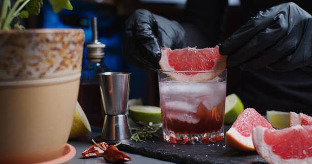 istock Human hands are making a mocktail with various citrus juices and rosemary 1286671427