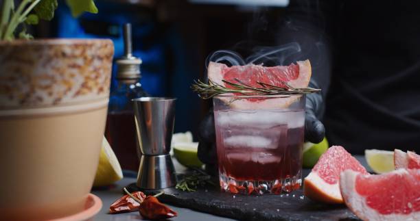 istock Human hands are making a mocktail with various citrus juices and smoking rosemary 1286671455