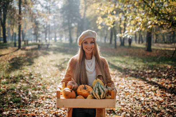 istock Woman carrying pumpkin and squash 1286672307