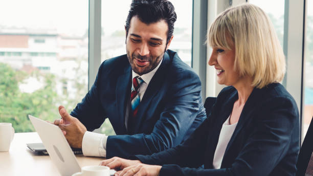 istock Two business people talk project strategy at office 1286672945