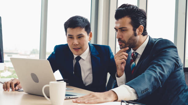 istock Two business people talk project strategy at office 1286673915