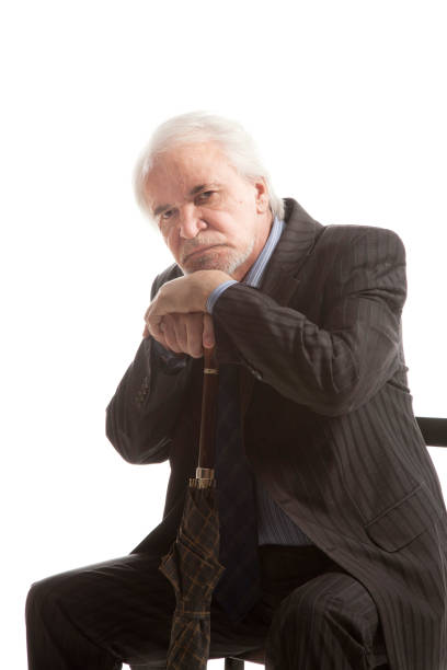 istock Senior businessman with umbrella 1286674279