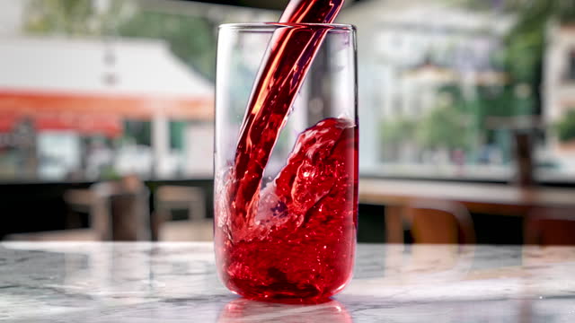 sour cherry juice pouring in cafe environment