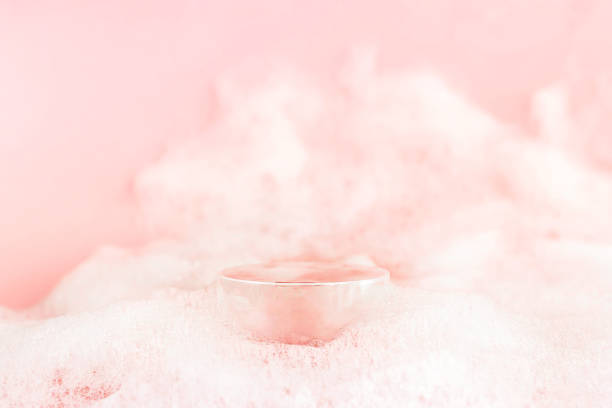 Abstract empty podium with suds on pastel pink background for presentation and exhibitions cosmetic product. Minimal concept.