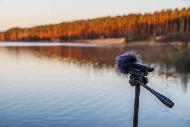 istock Portable recorder stands on a tripod on the lake shore 1286678404