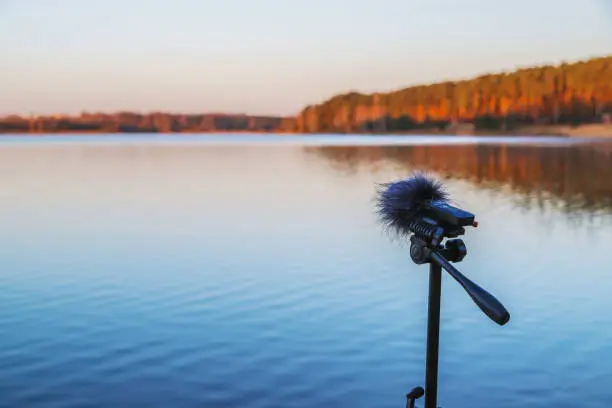 Photo of Portable recorder stands on a tripod on the lake shore