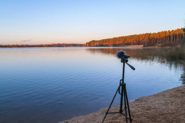 istock Portable recorder stands on a tripod on the lake shore 1286678413