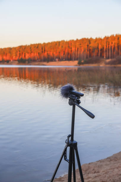 istock Portable recorder stands on a tripod on the lake shore 1286678455
