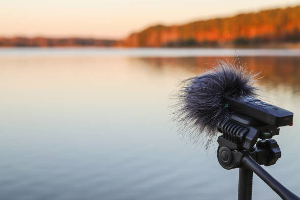 Portable recorder stands on a tripod on the lake shore