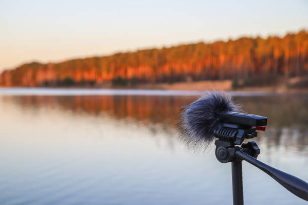 Portable recorder stands on a tripod on the lake shore