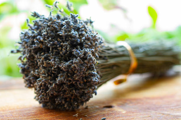 Bouquet of dried lavender flowers on a wooden table, close up