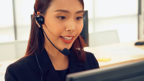 istock Business people wearing headset working in office 1286680195