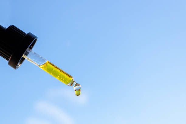 istock CBD oil drops, dropper over blue sky background 1286681363