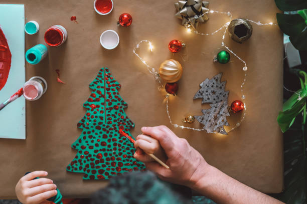 istock Father helping child making christmas decorations 1286681530