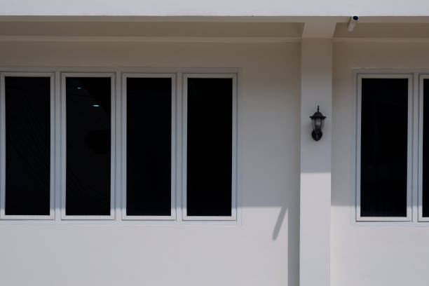 istock Sunlight and shadow on glass windows surface outside of house building wall 1286681825