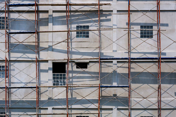 istock Sunlight and shadow on scaffolding surface outside of high building in construction site 1286681834