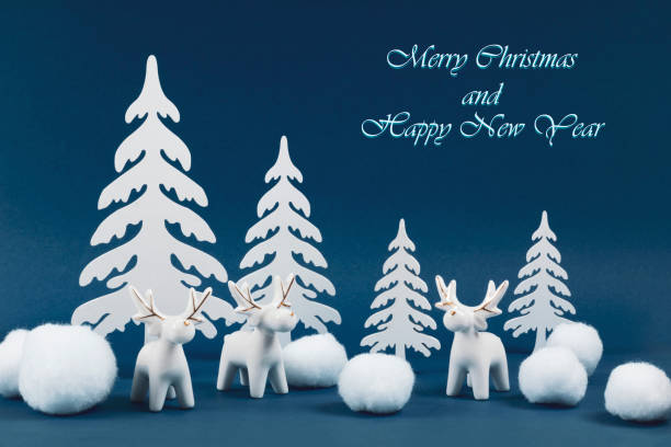 istock Christmas composition with deer figurines and Christmas tree decorations on a blue background. 1286682487