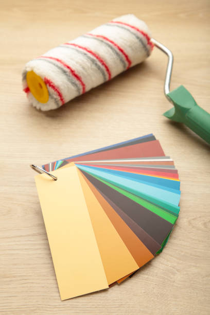 istock Coloured swatches and paint roller on table. 1286682641
