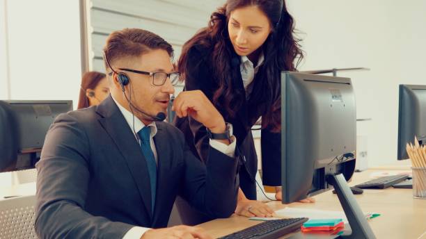 istock Business people wearing headset working in office 1286685109