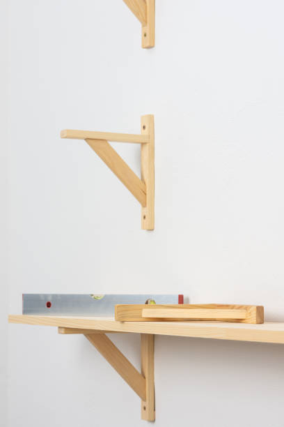 istock The process of attaching a wooden shelf to the wall 1286685141