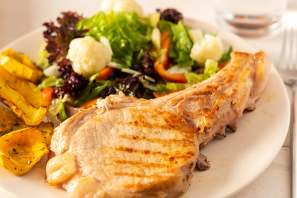 istock Pork entrecote on the bone with pumpkin and salad 1286685184