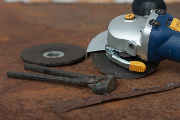 istock Black splitting pliers and angle grinder with thinner cut-off disc and  grinding disc on old rusty metal sheet 1286685399