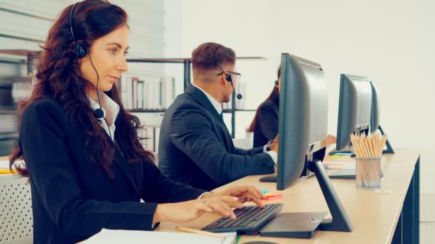istock Business people wearing headset working in office 1286685616