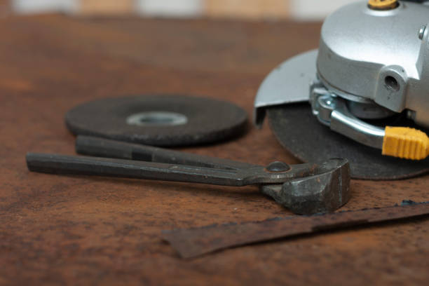 istock Black splitting pliers and angle grinder with thinner cut-off disc and  grinding disc on old rusty metal sheet 1286687080