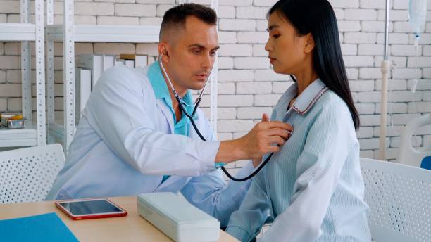 istock Doctor in professional uniform examining patient at hospital 1286687267