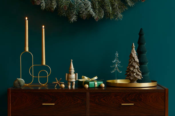 istock Christmas composition on brwon wooden commode with decoration, christmas tree, gifts and accessories in cozy home decor. Copy space. Template. 1286687850