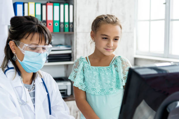 istock A pediatrician examines a child during a COVID 19 pandemic 1286688487