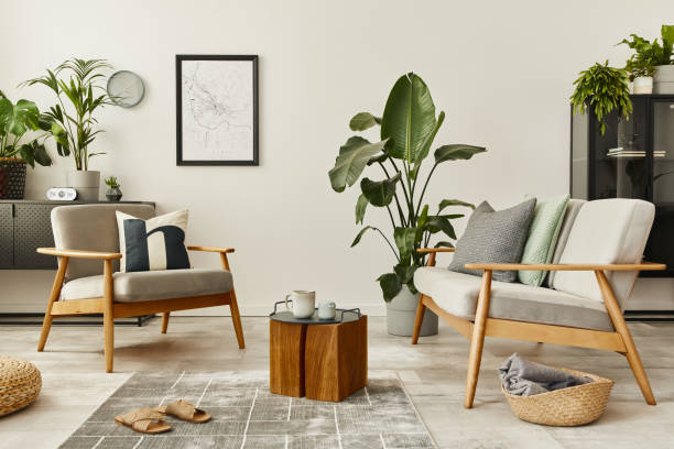 istock Modern retro concept of home interior with design sofa, armchair, coffee table, plants, mock up poster map, carpet and personal accessoreis. Stylish home decor of living room. 1286689222