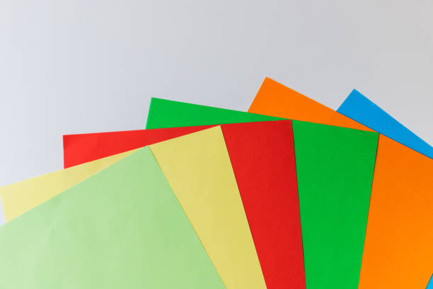 istock Pattern of multi-colored paper laid out in the form of rays one after another on a white background 1286689452