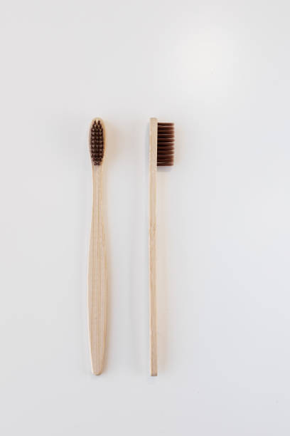 istock View of bamboo toothbrush front and side. Vertical orientation. Dental zero waste and no plastic concept. Copy space, top view. Natural organic white brush. Isolated on white background. 1286689503