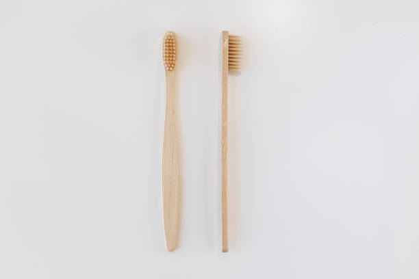 istock View of bamboo toothbrush front and side. Horizontal orientation. Dental zero waste and no plastic concept. Copy space, top view. Natural organic white brush. Isolated on white background. 1286689554