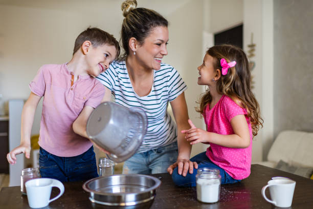 istock Happy family making cake together 1286689679