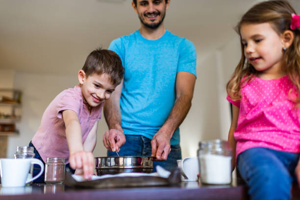 istock Happy family making cake together 1286690490