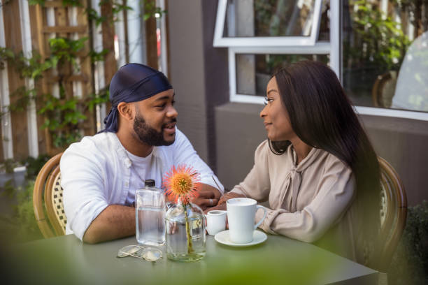 istock Affectionate African couple sit at the coffee shop 1286690755
