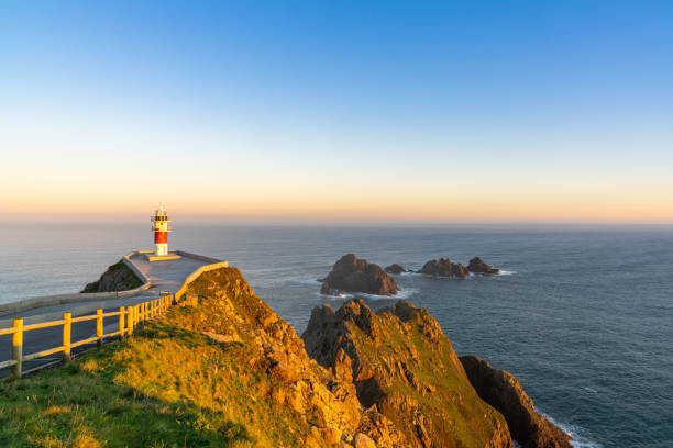 Cabo Ortegal lighthouse on the coast of Galicia at sunrise the Cabo Ortegal lighthouse on the coast of Galicia at sunrise galicia stock pictures, royalty-free photos & images