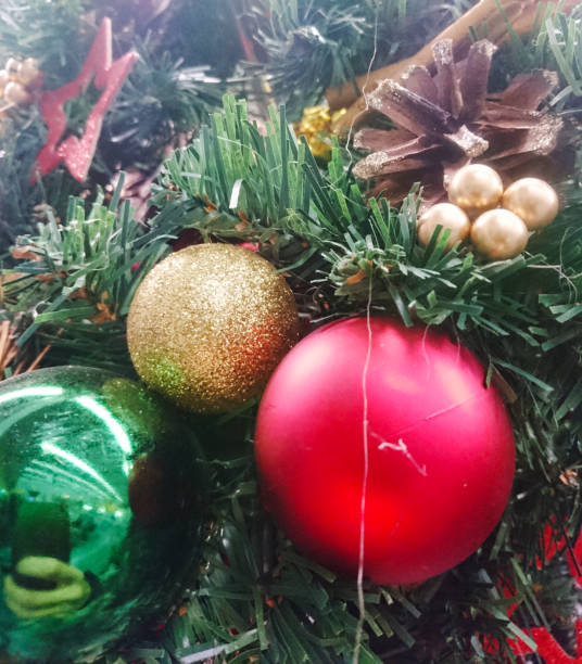 istock Colored balls hanging on a branch of a Christmas tree. 1286694404