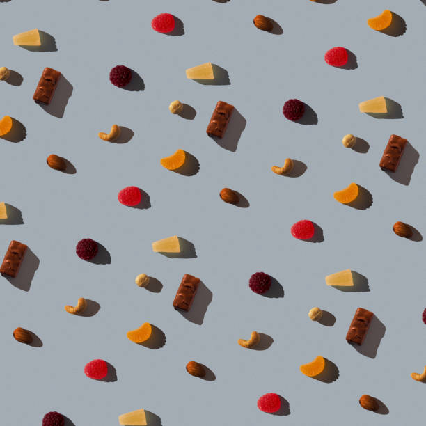 istock Seamless background with marmalade, various nuts and chocolate on a dirty blue texture. Hard shadow. Top view, flat lay 1286694451
