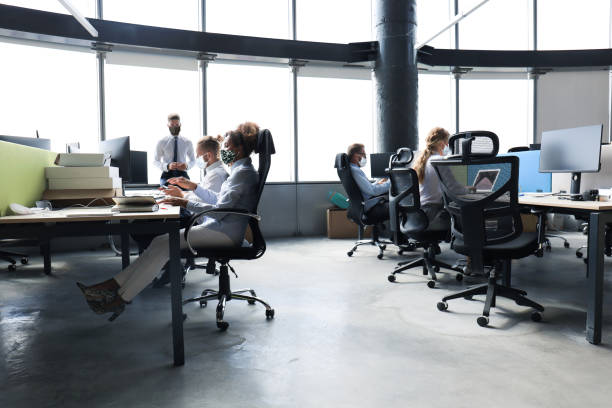 istock Business team in protective masks works in the office. 1286694795