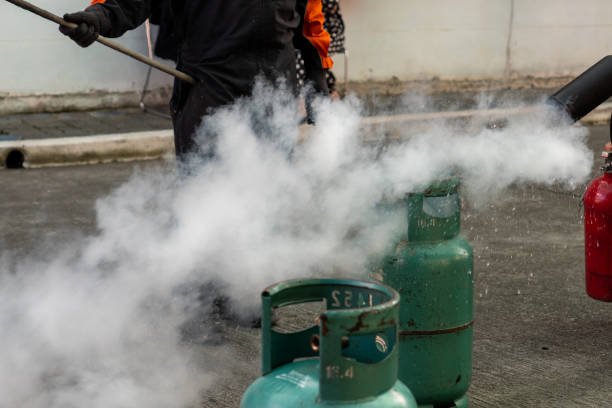 istock Man teaches how to use carbon dioxide  (CO2) fire extinguishers to extinguish fires from LPG cooking gas tanks. 1286694800