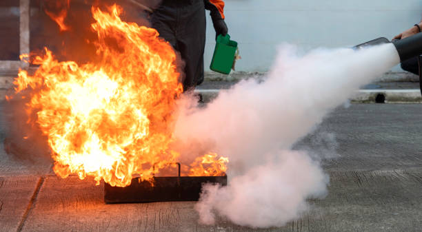 istock Man teaches or training how to use carbon dioxide  (CO2) fire extinguishers to extinguish fires from fuel. 1286694826