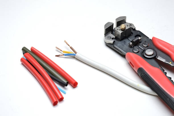 istock wire stripper, shielded three-core wire and heat shrink tubing on a white background. 1286695562