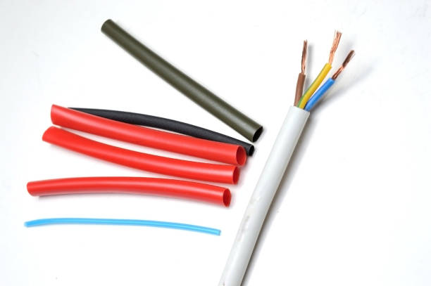 istock heat shrink tubing and a three-core stripped wire on a white background. 1286695570