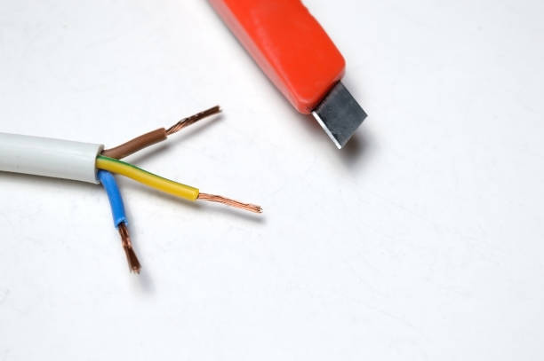 istock stripped three-wire, electric cable and stationery knife. on white background. 1286695608