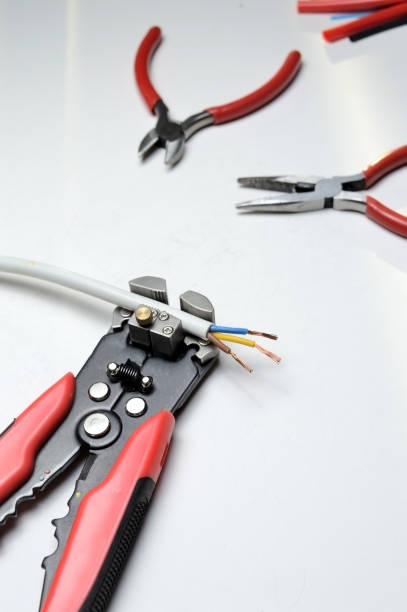 istock wire stripper, shielded three-core wire and heat shrink tubing on a white background. 1286695724